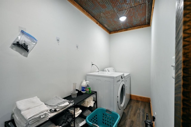 washroom featuring wood finished floors, laundry area, baseboards, and separate washer and dryer