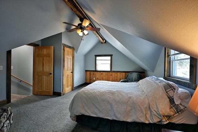 carpeted bedroom with a ceiling fan, lofted ceiling with beams, and baseboards