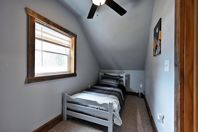 bedroom featuring lofted ceiling, carpet flooring, and baseboards