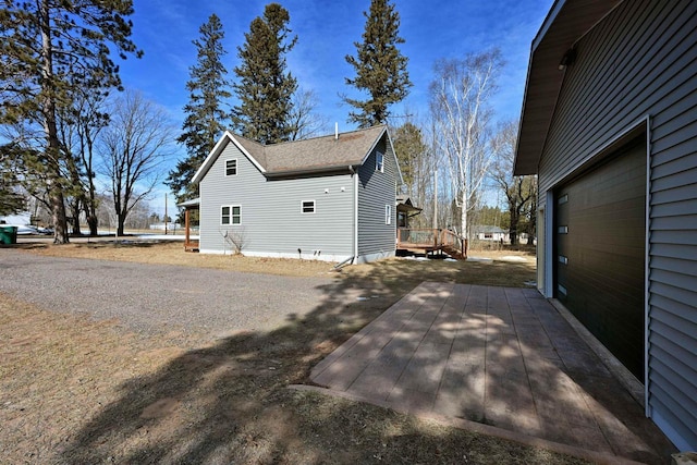 view of property exterior with roof with shingles