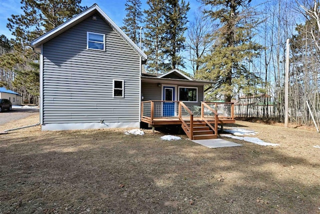 back of property featuring a wooden deck