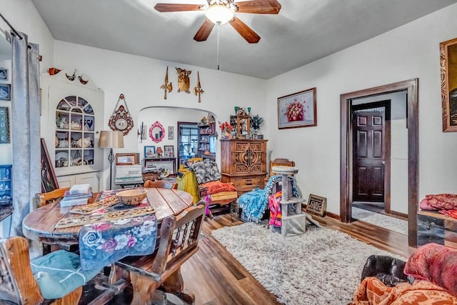 playroom featuring baseboards, a ceiling fan, and wood finished floors