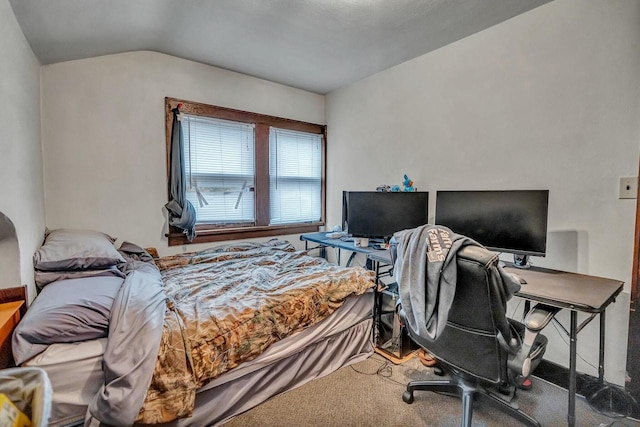 bedroom featuring vaulted ceiling and carpet flooring