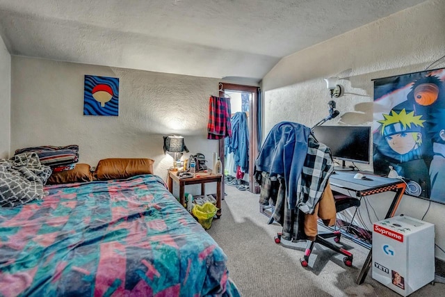 bedroom with lofted ceiling, carpet flooring, a textured wall, and a textured ceiling