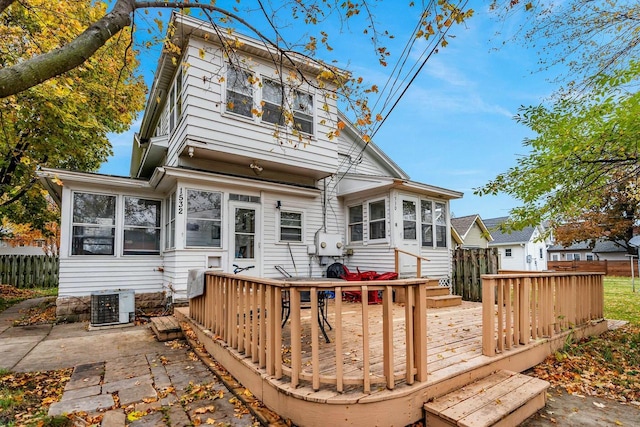 back of house featuring cooling unit, fence, and a deck