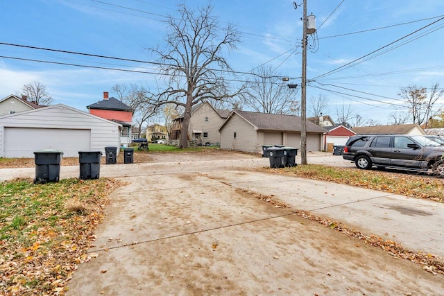 exterior space with a detached garage and an outdoor structure