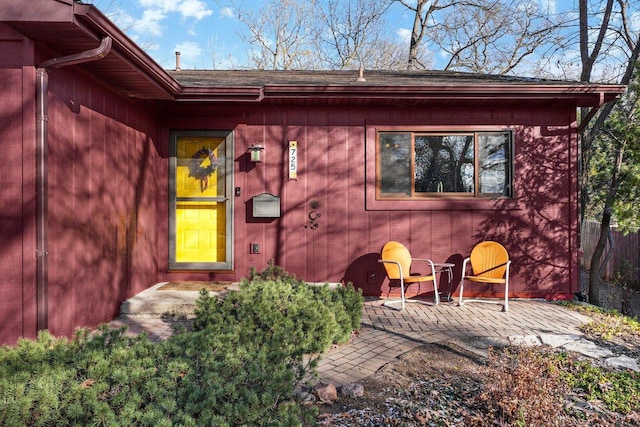 view of exterior entry with a patio