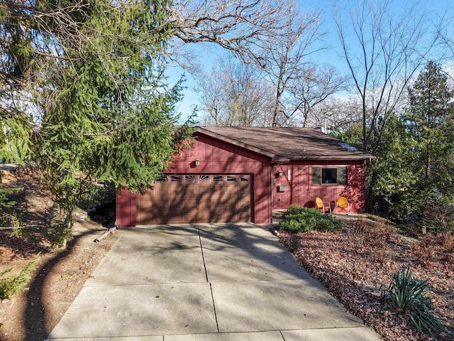 garage featuring concrete driveway