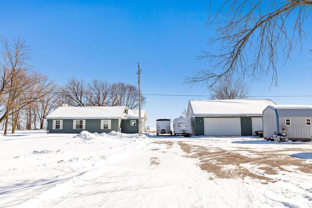 view of front of house with an outbuilding and an attached garage