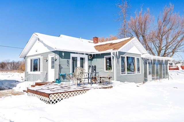 snow covered house with a chimney