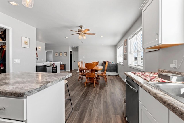 kitchen featuring dark wood-type flooring, recessed lighting, white cabinetry, and dishwasher