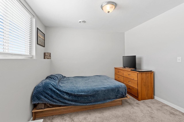 bedroom featuring carpet floors and baseboards