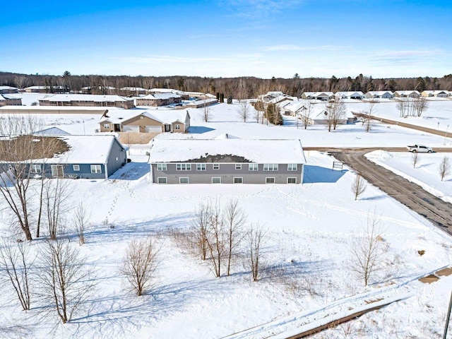 snowy aerial view with a residential view