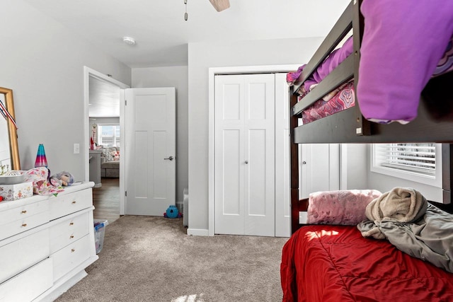 bedroom with carpet floors, a closet, and a ceiling fan