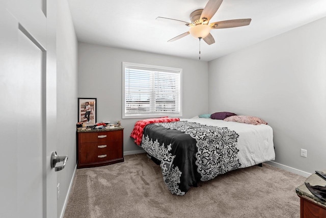 bedroom with light carpet, baseboards, and a ceiling fan