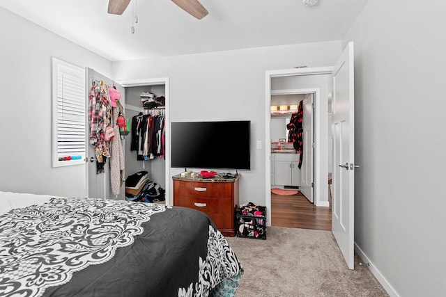 carpeted bedroom featuring a closet, a ceiling fan, and baseboards