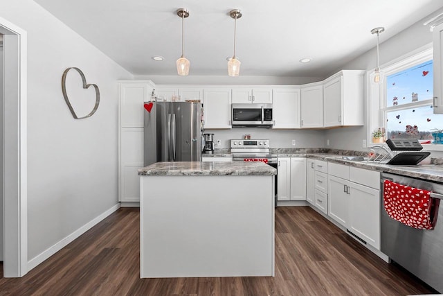 kitchen with dark wood-style floors, appliances with stainless steel finishes, and white cabinetry