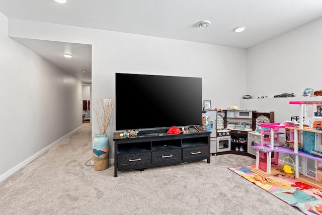 game room with light colored carpet and baseboards