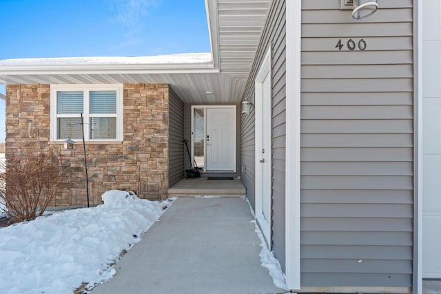 property entrance featuring stone siding