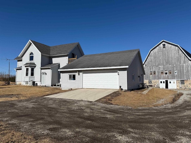 N3820 Fairwood Rd, Reeseville, WI 53579 - view of front of property featuring a barn, an outbuilding, concrete driveway, and an attached garage