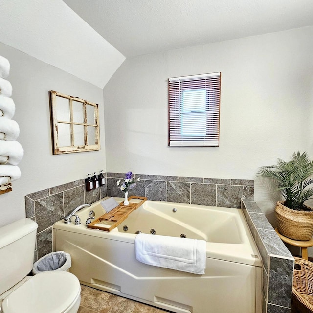 N3820 Fairwood Rd, Reeseville, WI 53579 - bathroom with toilet, a whirlpool tub, and vaulted ceiling