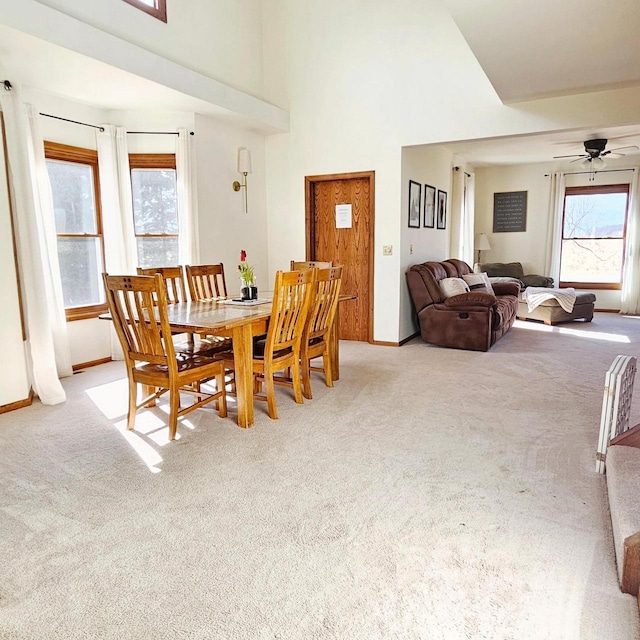 N3820 Fairwood Rd, Reeseville, WI 53579 - dining space featuring light carpet, baseboards, ceiling fan, and a high ceiling