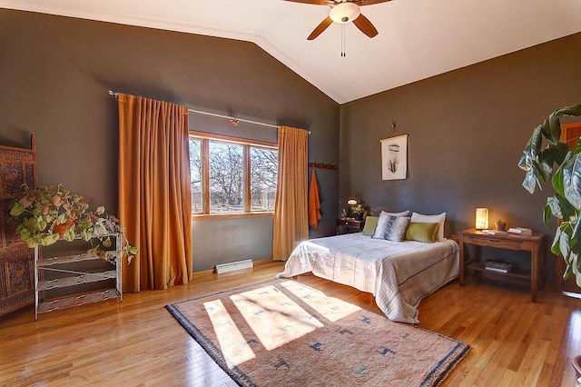 bedroom featuring vaulted ceiling, light wood-style flooring, and a ceiling fan