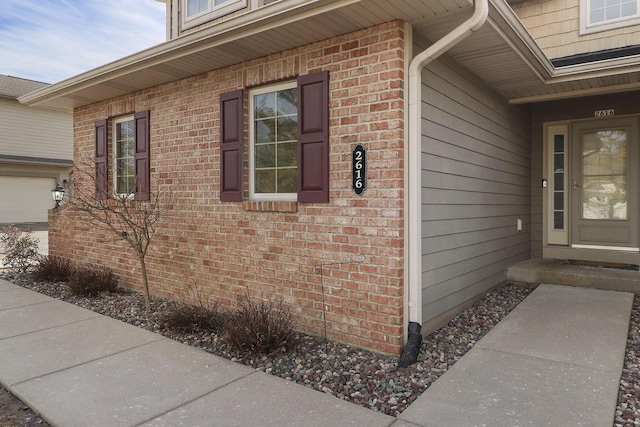 doorway to property featuring brick siding