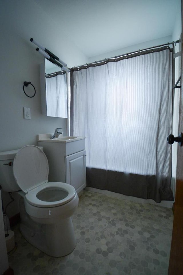 bathroom with toilet, shower / tub combo with curtain, and vanity