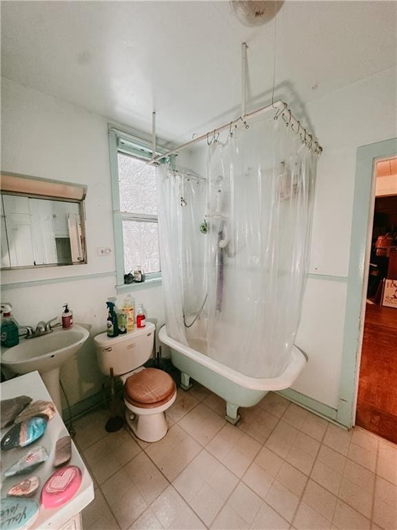 bathroom featuring a sink and shower / bath combo with shower curtain