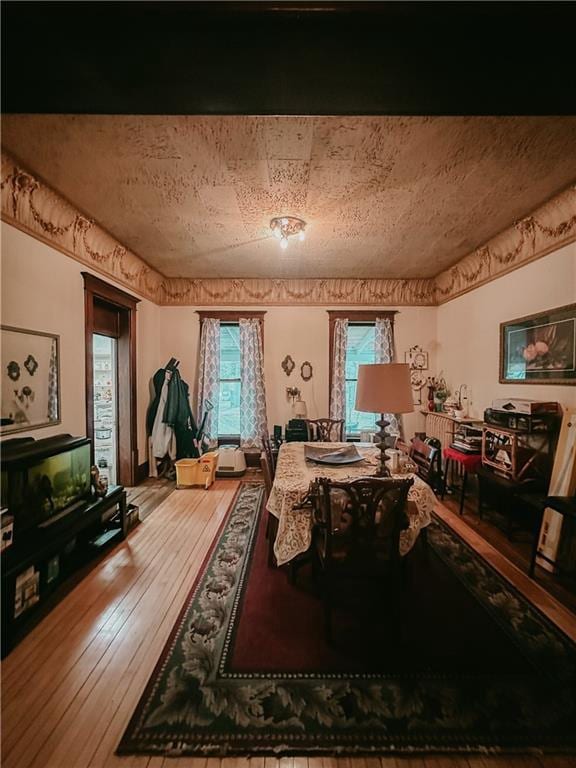 dining space with plenty of natural light and wood-type flooring