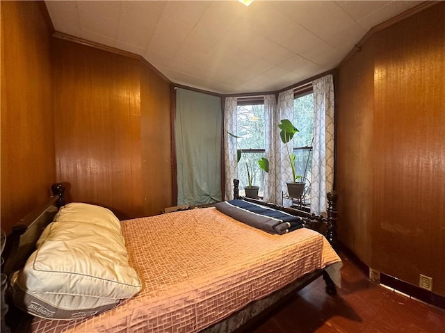 bedroom with vaulted ceiling, baseboards, and wooden walls