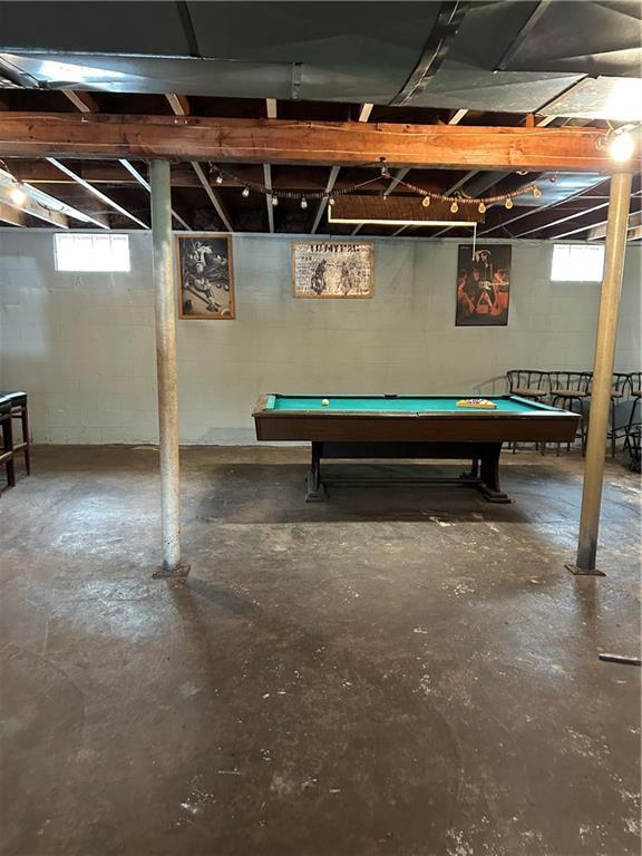 below grade area with pool table and plenty of natural light