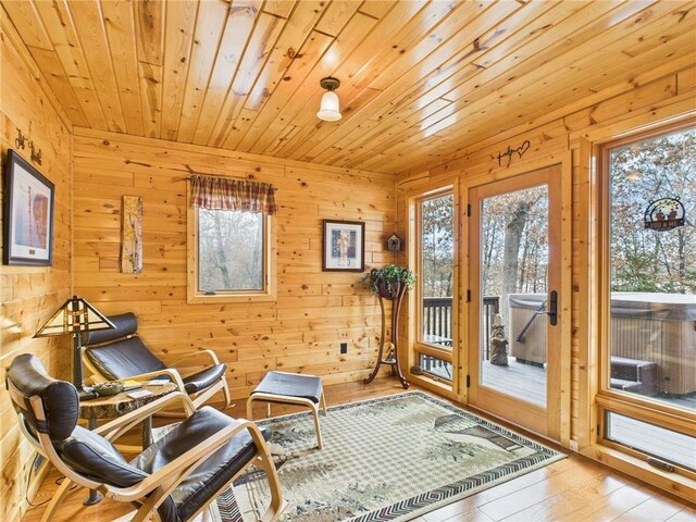 sitting room featuring wood ceiling and hardwood / wood-style floors