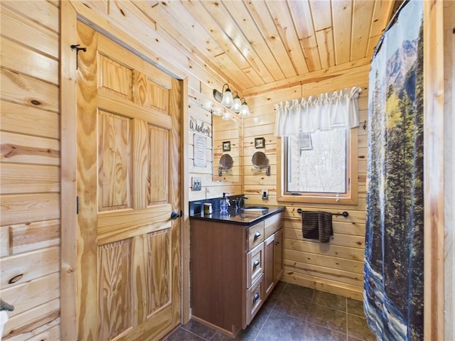 bathroom featuring wooden ceiling, wood walls, tile patterned flooring, and vanity