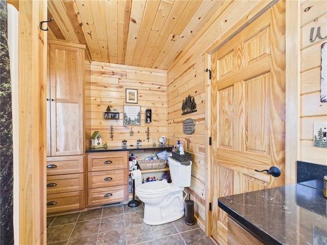 bathroom with toilet, wood walls, tile patterned flooring, and wood ceiling