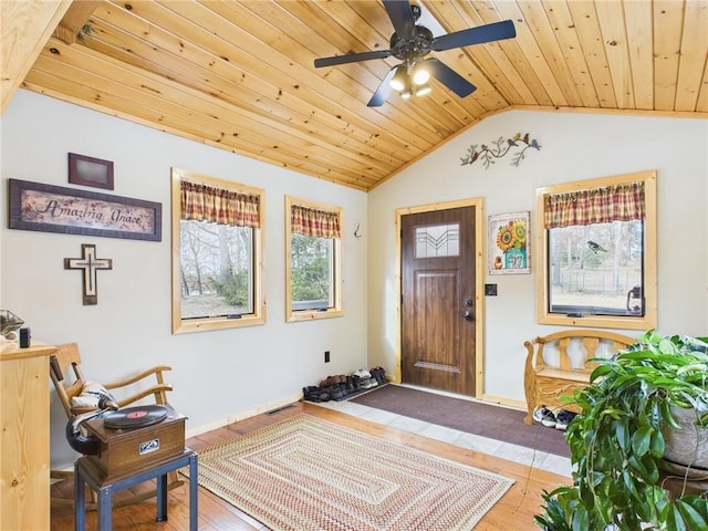 foyer entrance with visible vents, baseboards, lofted ceiling, wood ceiling, and ceiling fan