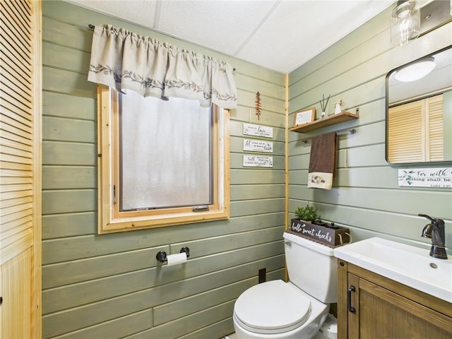 half bathroom with vanity and toilet