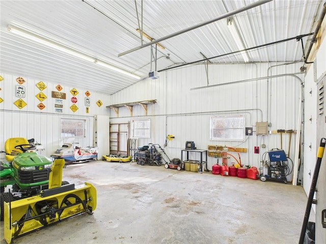 garage with metal wall and a garage door opener