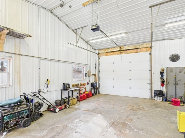 garage with metal wall and a garage door opener