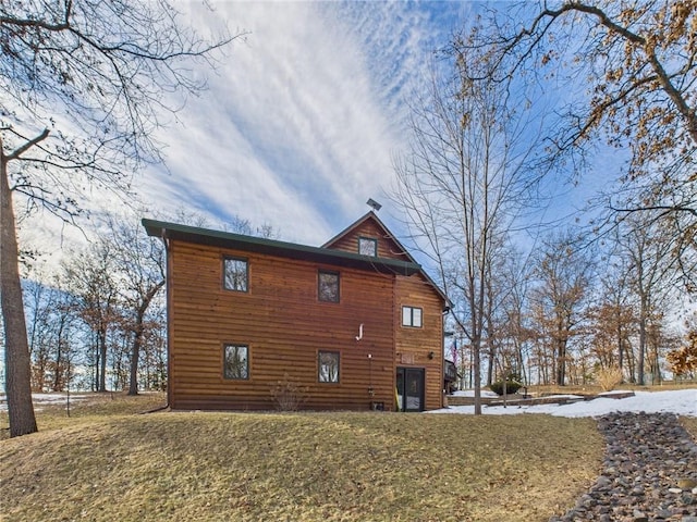 view of side of home with a lawn