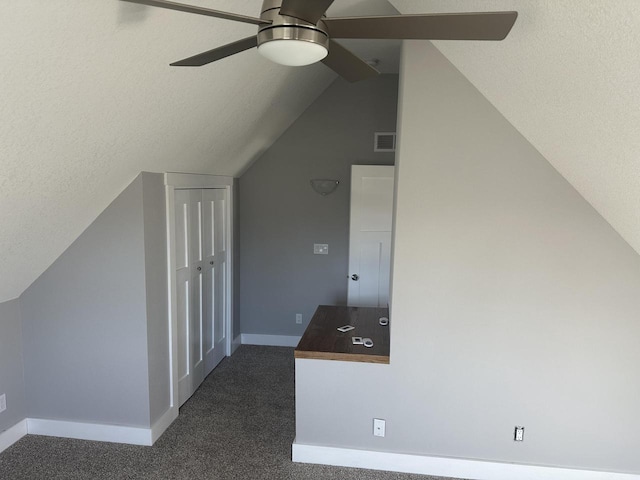 bonus room with lofted ceiling, baseboards, visible vents, and dark colored carpet