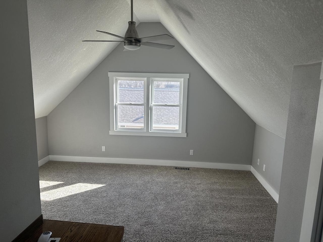 bonus room featuring lofted ceiling, baseboards, visible vents, and carpet flooring