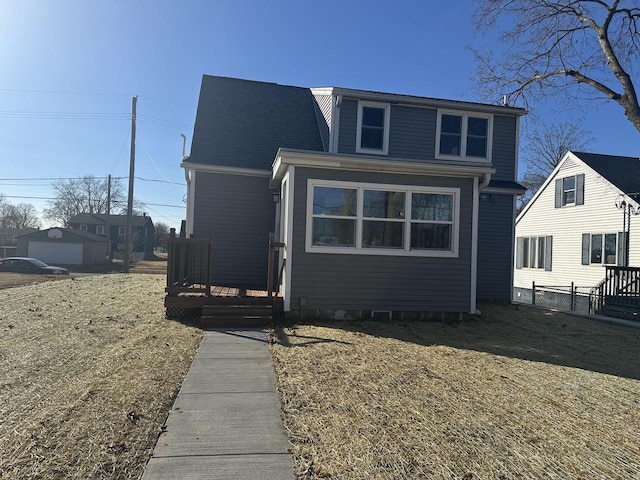 view of front of property featuring fence