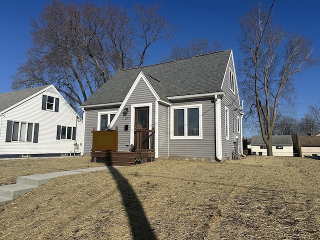 bungalow-style house with roof with shingles