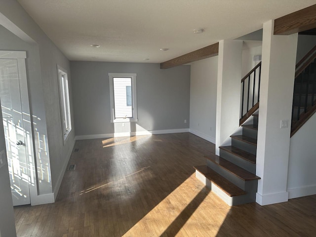 interior space with visible vents, stairs, baseboards, and wood finished floors