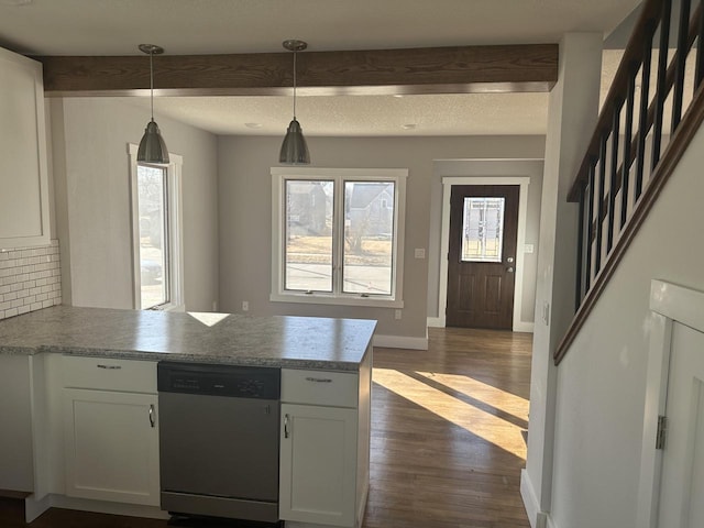 kitchen featuring dark wood-style flooring, beam ceiling, backsplash, stainless steel dishwasher, and a peninsula