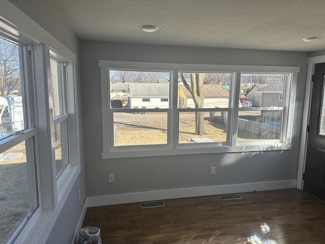 unfurnished sunroom with a wealth of natural light and visible vents