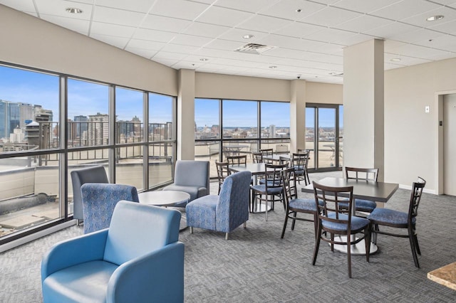 sunroom / solarium with visible vents and a view of city