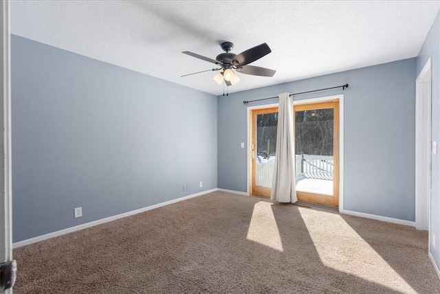 empty room with carpet, ceiling fan, a textured ceiling, and baseboards